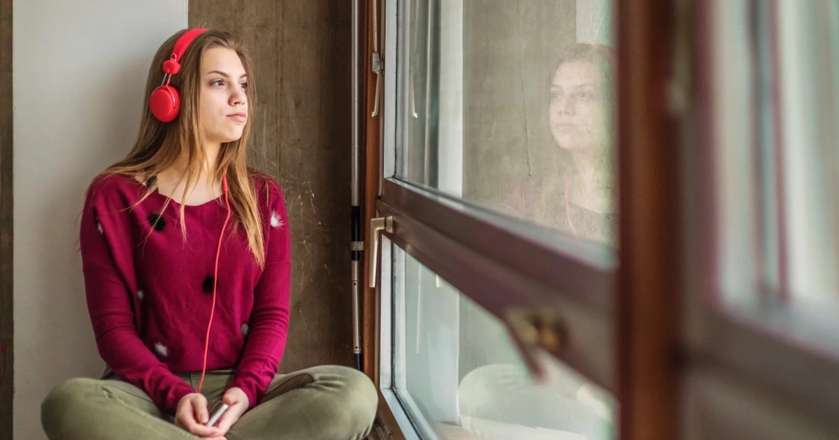 Image shows teen depressed due to social impact of teenage suicide