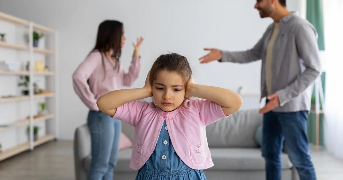 Young girl experiencing childhood trauma in the form of an abusive household with parents constantly arguing.