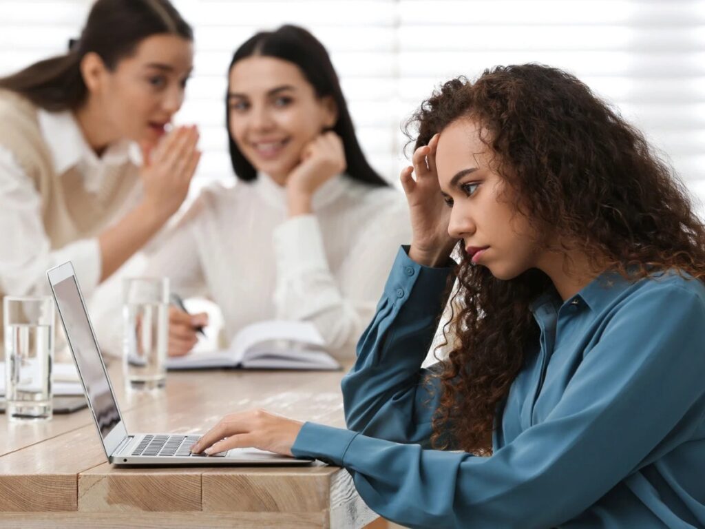 Image shows woman of colour experiencing discrimination. Learn how to deal with discrimination today,