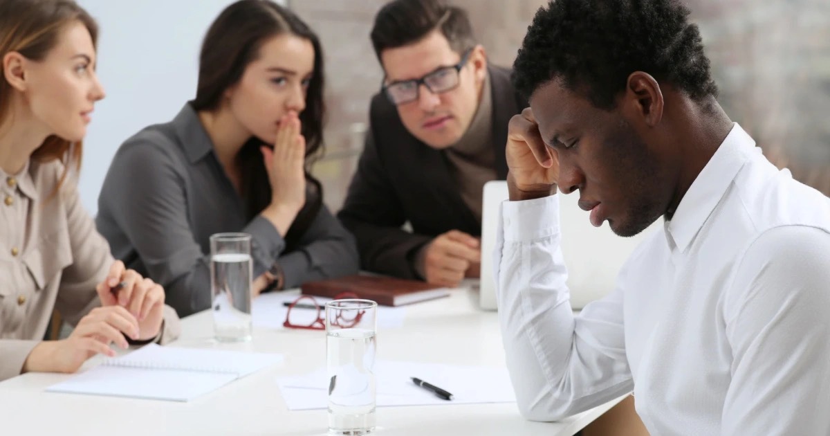 Image shows black man being discriminated against at work